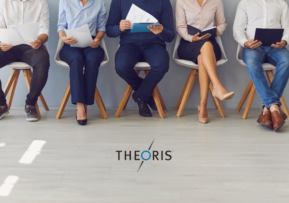 Job candidates seated in a row holding resumes during an interview process, representing IT and engineering staffing services by Theoris.