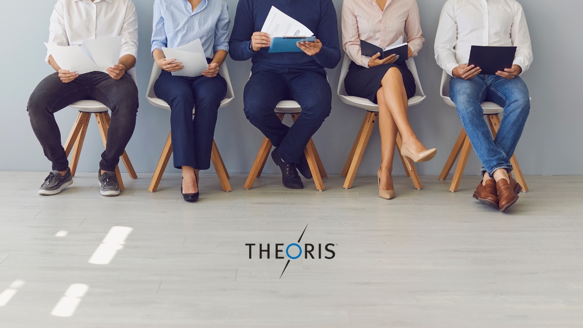Job candidates seated in a row holding resumes during an interview process, representing IT and engineering staffing services by Theoris.